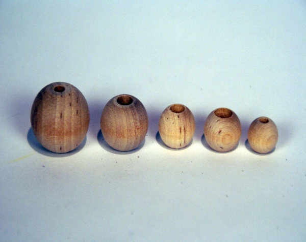 Custom wood turnings made into five plain unfinished wooden beads in various sizes.